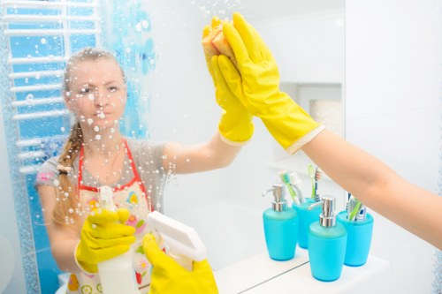 Person preparing oven cleaning supplies in kitchen