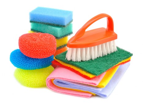 Dusting and sanitizing a modern bathroom during house cleaning